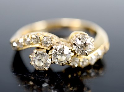 Lot 2604 - A yellow metal diamond three-stone crossover...
