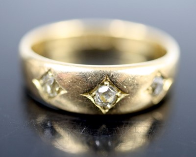 Lot 2608 - An 18ct yellow gold diamond three-stone ring,...