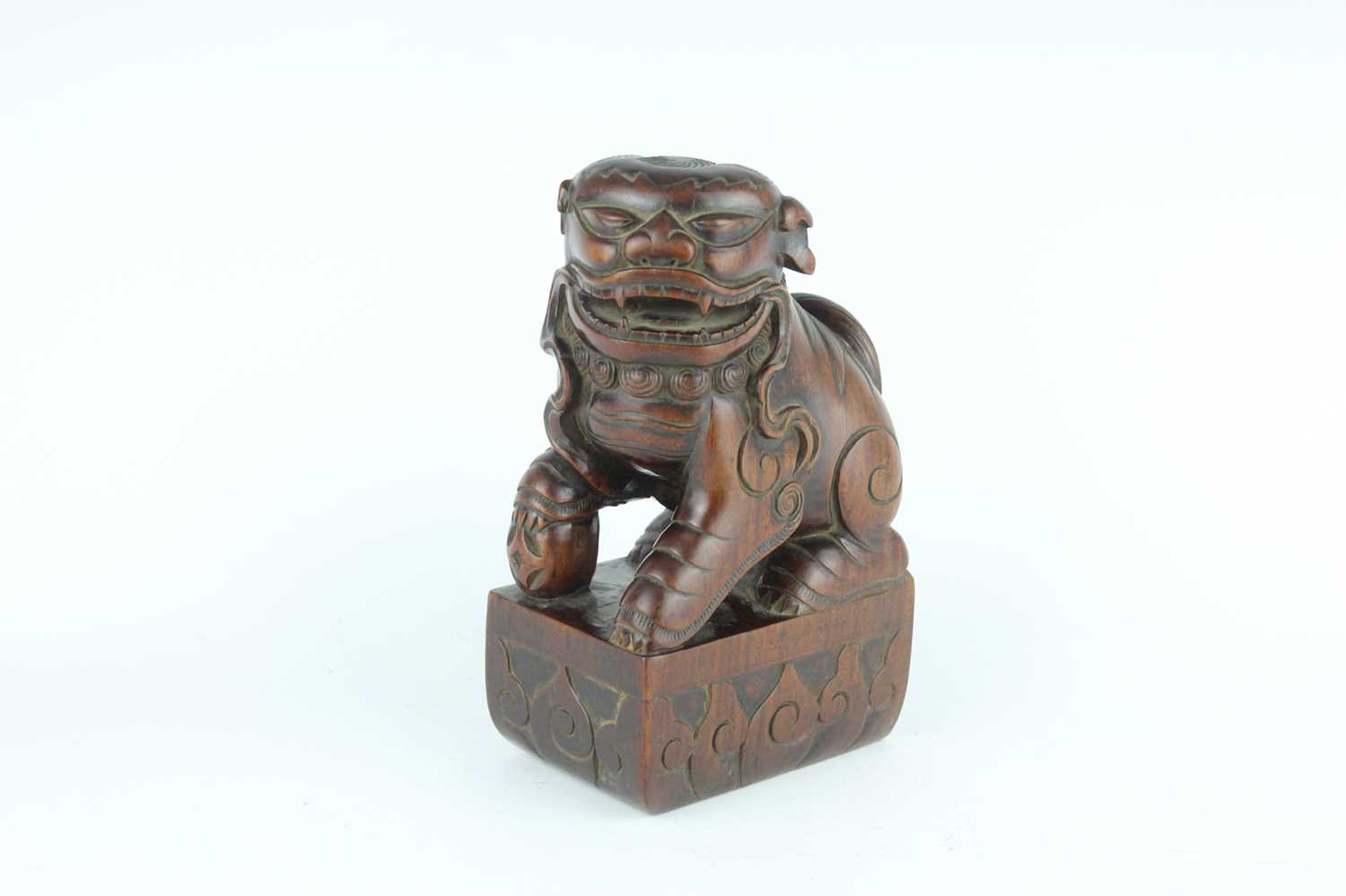 Lot 43 - A Chinese hardwood carved lion figure, Qing...