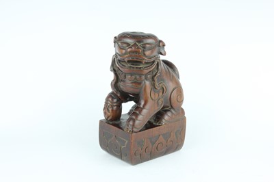 Lot 43 - A Chinese hardwood carved lion figure, Qing...