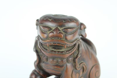 Lot 43 - A Chinese hardwood carved lion figure, Qing...