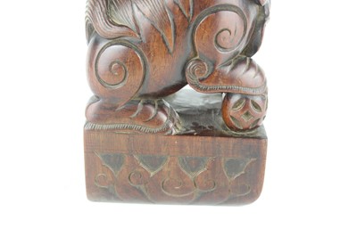 Lot 43 - A Chinese hardwood carved lion figure, Qing...