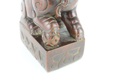 Lot 43 - A Chinese hardwood carved lion figure, Qing...