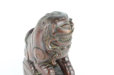 Lot 43 - A Chinese hardwood carved lion figure, Qing...