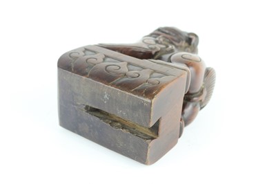 Lot 43 - A Chinese hardwood carved lion figure, Qing...