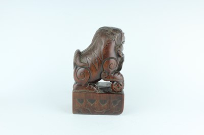 Lot 43 - A Chinese hardwood carved lion figure, Qing...