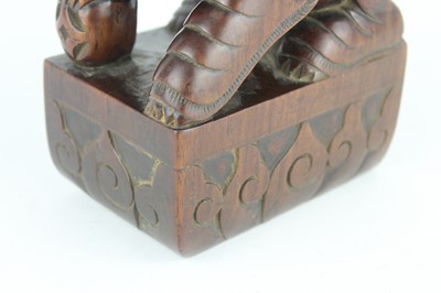 Lot 43 - A Chinese hardwood carved lion figure, Qing...