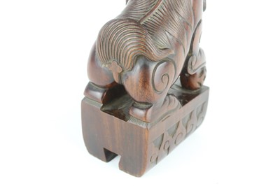 Lot 43 - A Chinese hardwood carved lion figure, Qing...