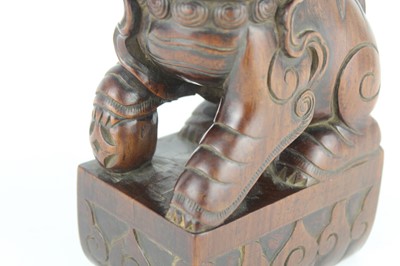 Lot 43 - A Chinese hardwood carved lion figure, Qing...