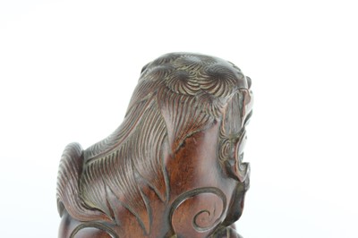Lot 43 - A Chinese hardwood carved lion figure, Qing...