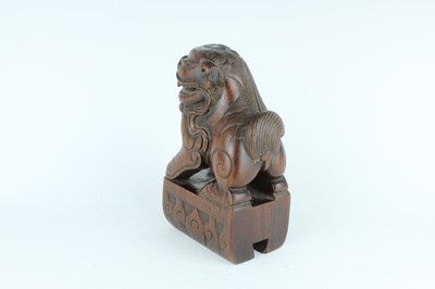 Lot 43 - A Chinese hardwood carved lion figure, Qing...