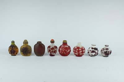 Lot 30 - A group of eight Chinese glass snuff bottles,...