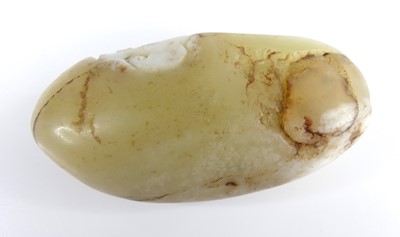 Lot 39 - A Chinese celadon and russet carved jade...