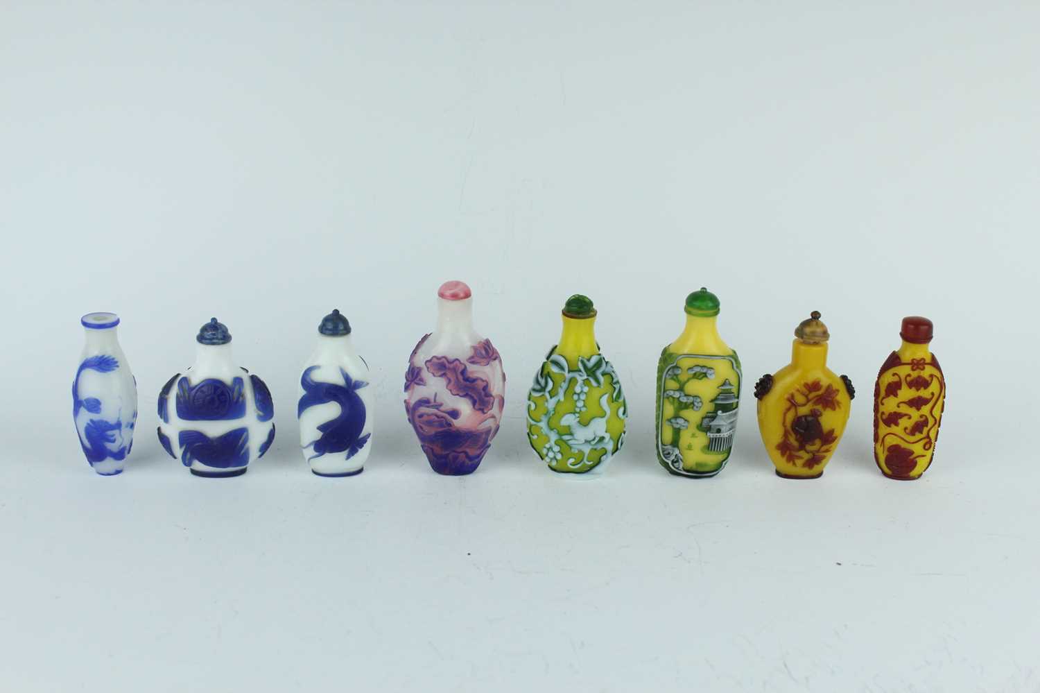 Lot 31 - A group of eight Chinese glass snuff bottles,...
