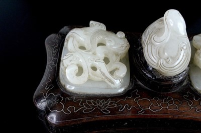 Lot 40 - A Chinese hardwood inlaid box with three jade...