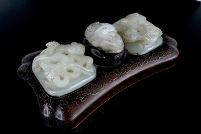 Lot 40 - A Chinese hardwood inlaid box with three jade...