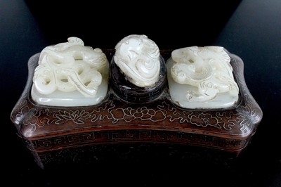 Lot 40 - A Chinese hardwood inlaid box with three jade...