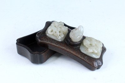 Lot 40 - A Chinese hardwood inlaid box with three jade...