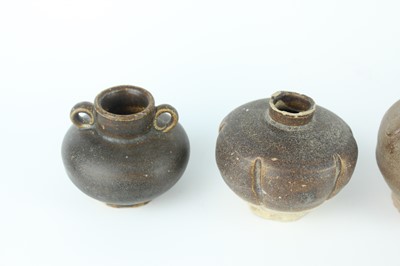 Lot 121 - Five small Chinese black-glazed stoneware pots,...