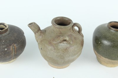 Lot 121 - Five small Chinese black-glazed stoneware pots,...