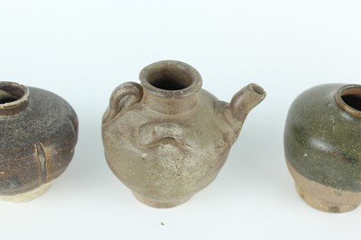 Lot 121 - Five small Chinese black-glazed stoneware pots,...