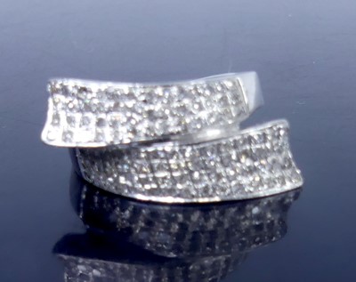 Lot 2774 - A modern 9ct white gold diamond set crossover...