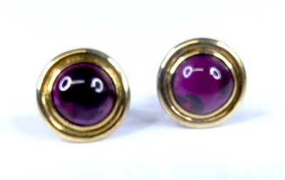 Lot 2786 - A pair of yellow metal cabochon garnet set ear...
