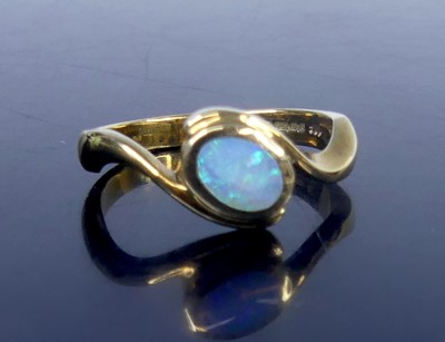 Lot 2788 - A 9ct gold opal set crossover dress ring, the...