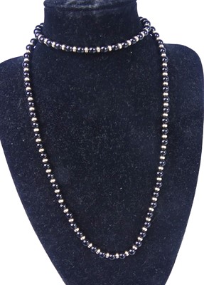 Lot 2789 - A beaded black onyx necklace with yellow metal...