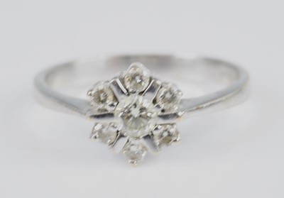 Lot 2620 - An 18ct white gold diamond flower head cluster...