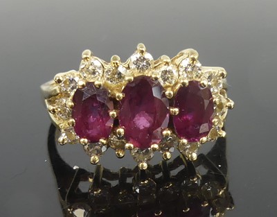 Lot 2296 - A yellow metal, ruby and diamond triple...