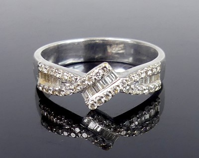 Lot 2781 - A contemporary white metal diamond half-hoop...
