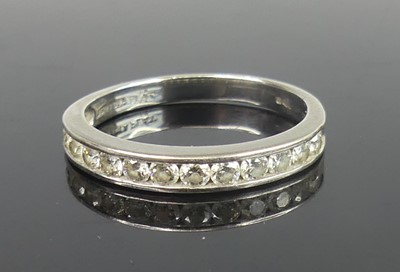Lot 2791 - A platinum diamond set half eternity ring,...