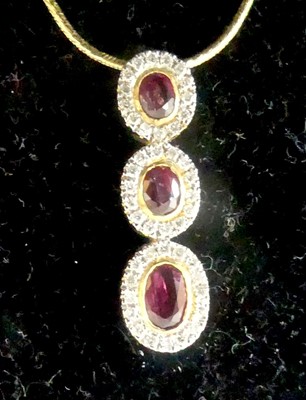 Lot 2805 - A yellow metal, ruby and diamond triple...