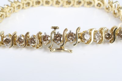 Lot 2822 - A yellow metal diamond tennis bracelet,...