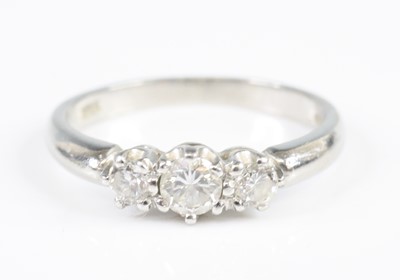 Lot 2825 - A platinum diamond three-stone ring, featuring...