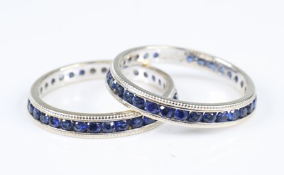 Lot 2841 - Two white metal sapphire eternity rings, one...