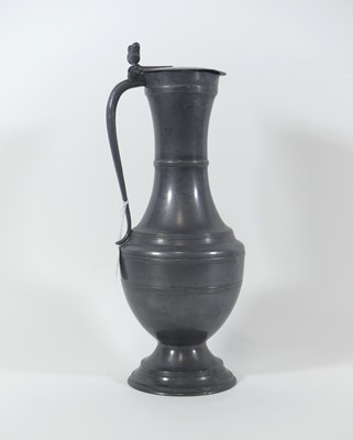 Lot 8 - A pewter ewer of baluster form, the hinged...