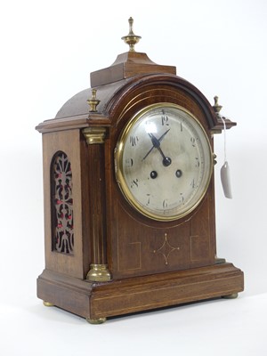 Lot 10 - An Edwardian walnut cased dome top mantel...