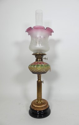 Lot 109 - A Victorian oil lamp, having a cranberry...