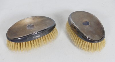 Lot 230 - A pair of 1970s silver-backed clothes brushes,...