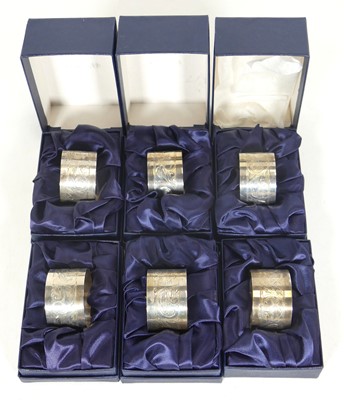 Lot 236 - A set of six modern silver napkin rings, each...