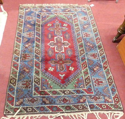 Lot 1168 - A blue, red and green ground woollen Kazak rug,...