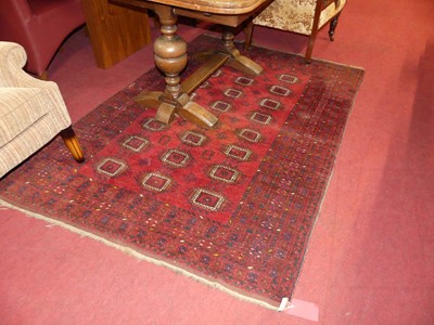 Lot 1170 - A Persian woollen red ground Bokhara rug,...