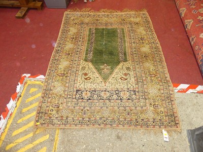 Lot 1173 - A Persian woollen prayer rug, the green...