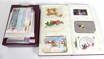 Lot 409 - A postcard album and contents, to include...