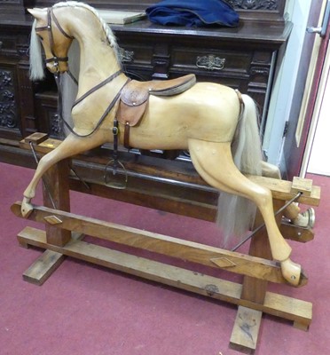 Lot 1179 - A carved birch child's rocking horse with tan...