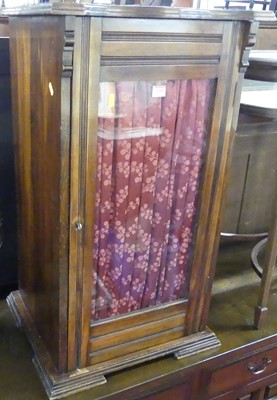 Lot 1209 - An Edwardian walnut single door glazed music...