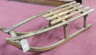 Lot 1240 - A vintage elm and metal bound sled, length 110cm