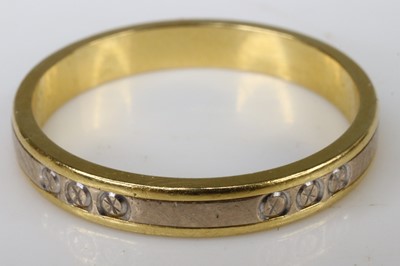 Lot 243 - An 18ct yellow and white gold wedding band,...